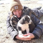 a person and a dog sitting on the ground