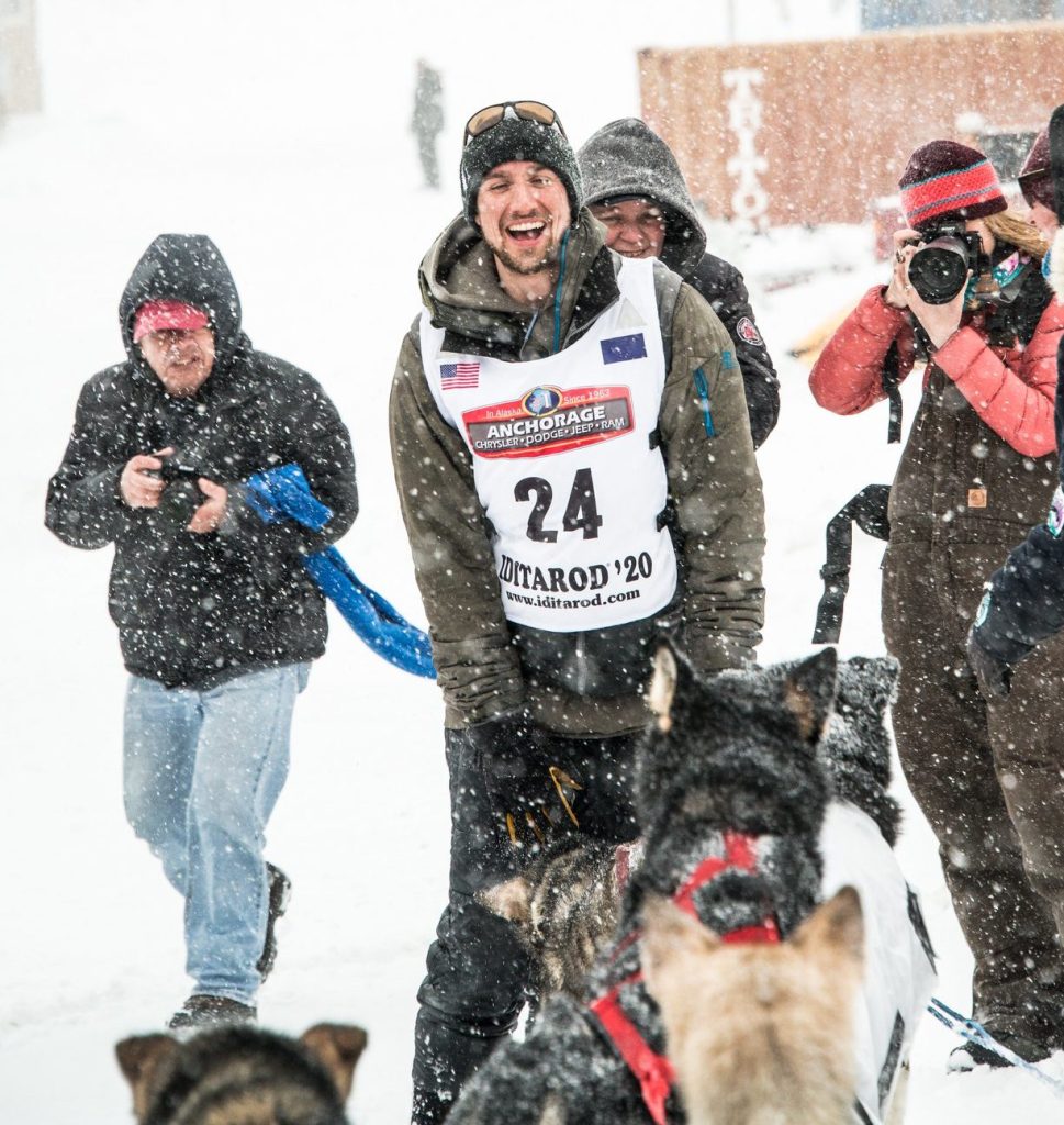 a person and a dog in the snow