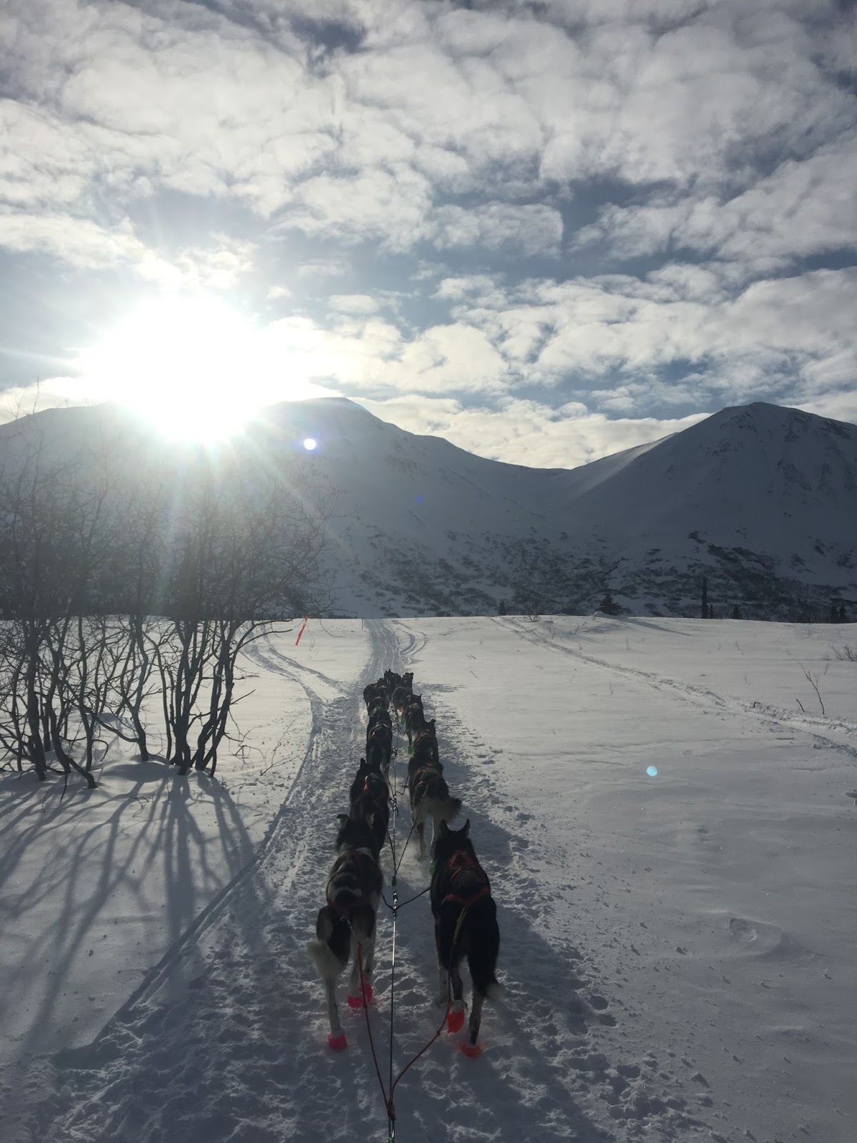a man walking across a snow covered mountain