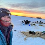 a person standing next to a body of water