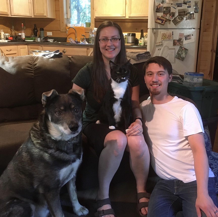 Zan Rowe holding a dog posing for the camera