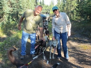 a group of people standing next to a dog